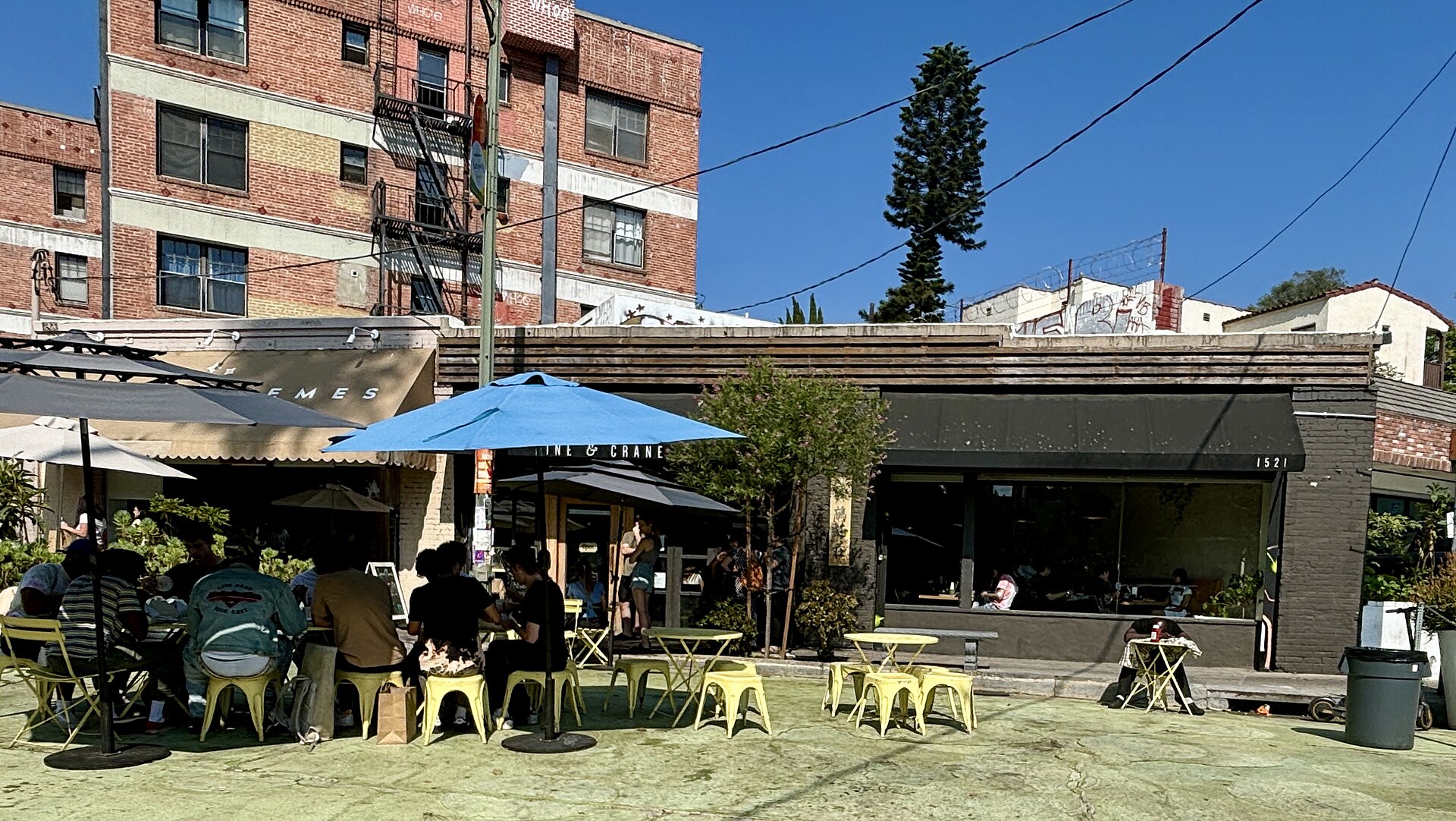 Diners at outdoor tables on the Pine and Crane restaurant patio in Silver Lake
